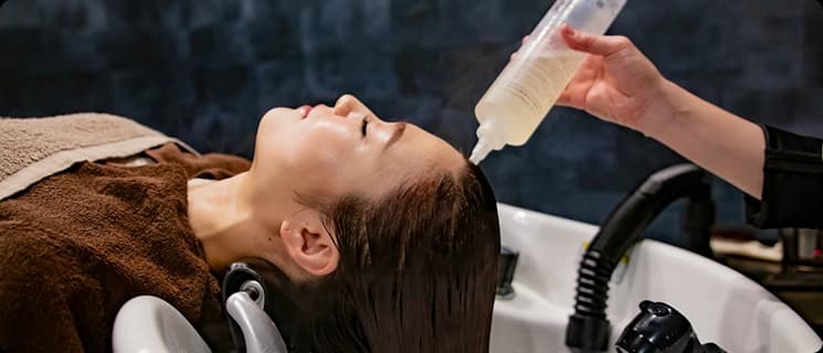 Client receiving a relaxing hair and scalp treatment at Looks Clinic